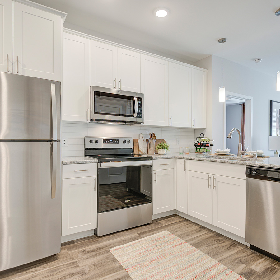 Kitchen area with modern appliances, kitchen island, and bright eating area.