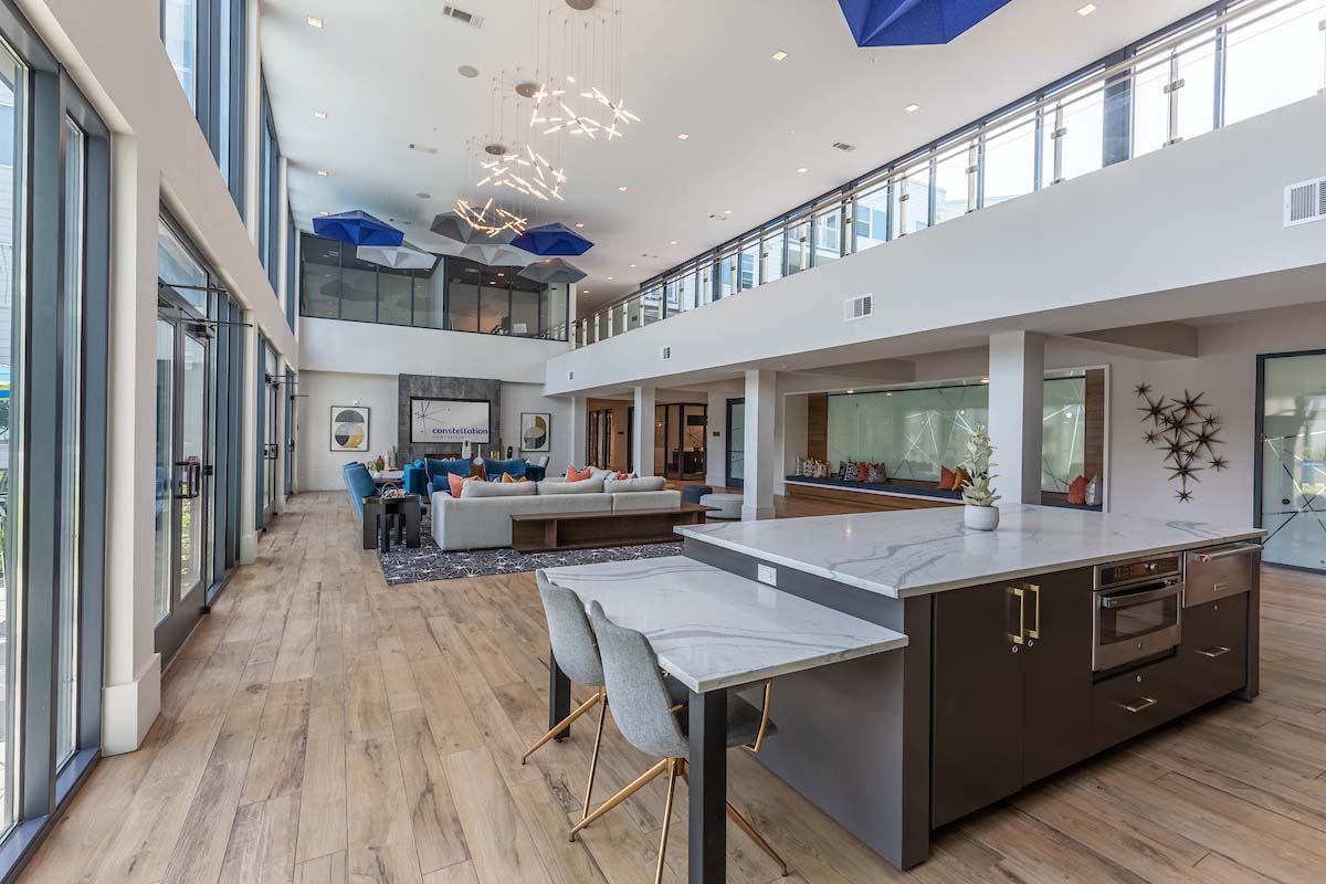 Constellation community lounge with plush seating and mezzanine.